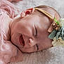 adorable, baby, child, close_up, cute, dress, face, flower, happy, headband, infant, lying_down, newborn, pink, polka_dot, portrait, skin, smile, soft_texture, toddler