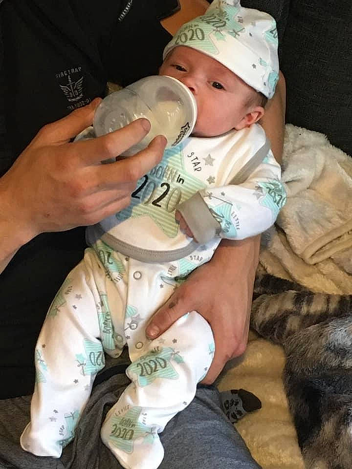 Leighton joined the competition — help win amazing prizes! baby, baby_toddler_clothing, baseball_cap, camouflage, cap, child, comfort, drinkware, hand, hat, headgear, headwear, human_leg, military_camouflage, nail, person, personal_protective_equipment, sitting, skin, thigh