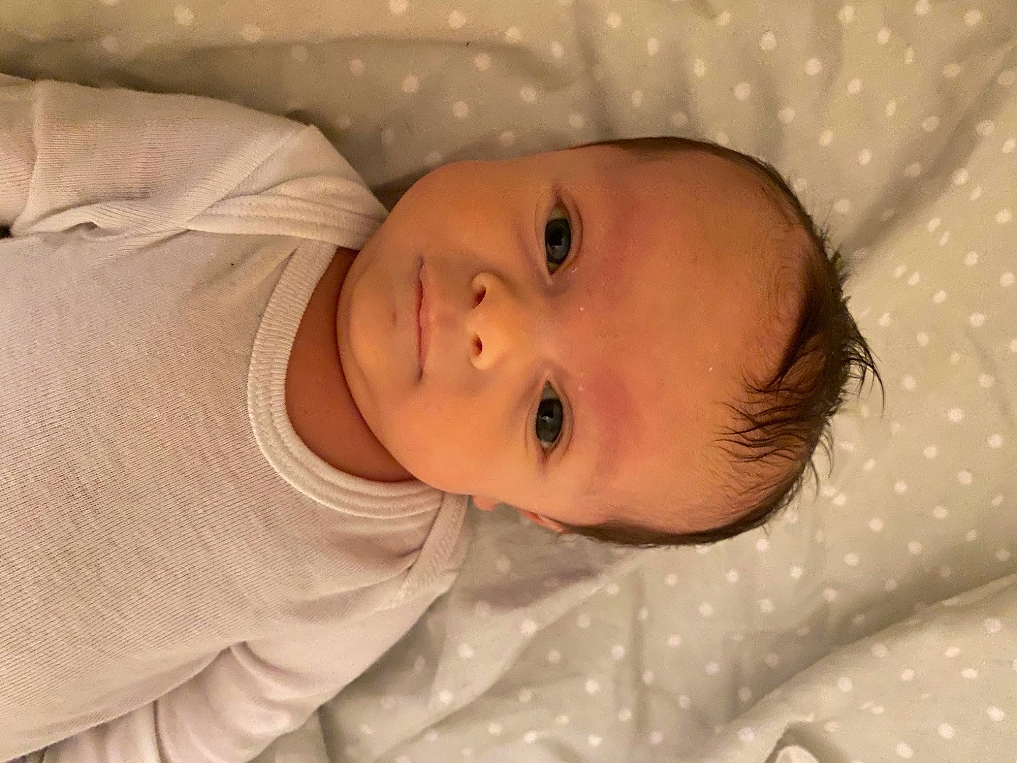 Kayne is registered to the contest to win money with this photo: baby, baby_toddler_clothing, cheek, child, close_up, comfort, eye, eyebrow, face, head, human_body, iris, linens, lip, mouth, nose, person, skin, sleeve, smile