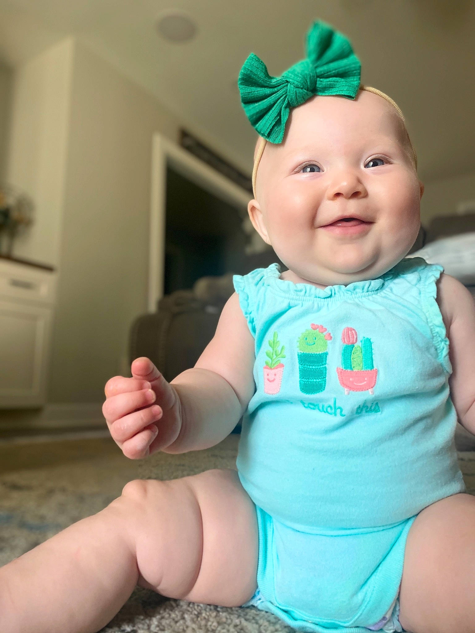 Laney is registered to the contest to win money with this photo: baby, baby_products, baby_toddler_clothing, blue, child, fashion_accessory, finger, hand, head, headgear, headwear, joy, person, skin, smile, toddler, turquoise