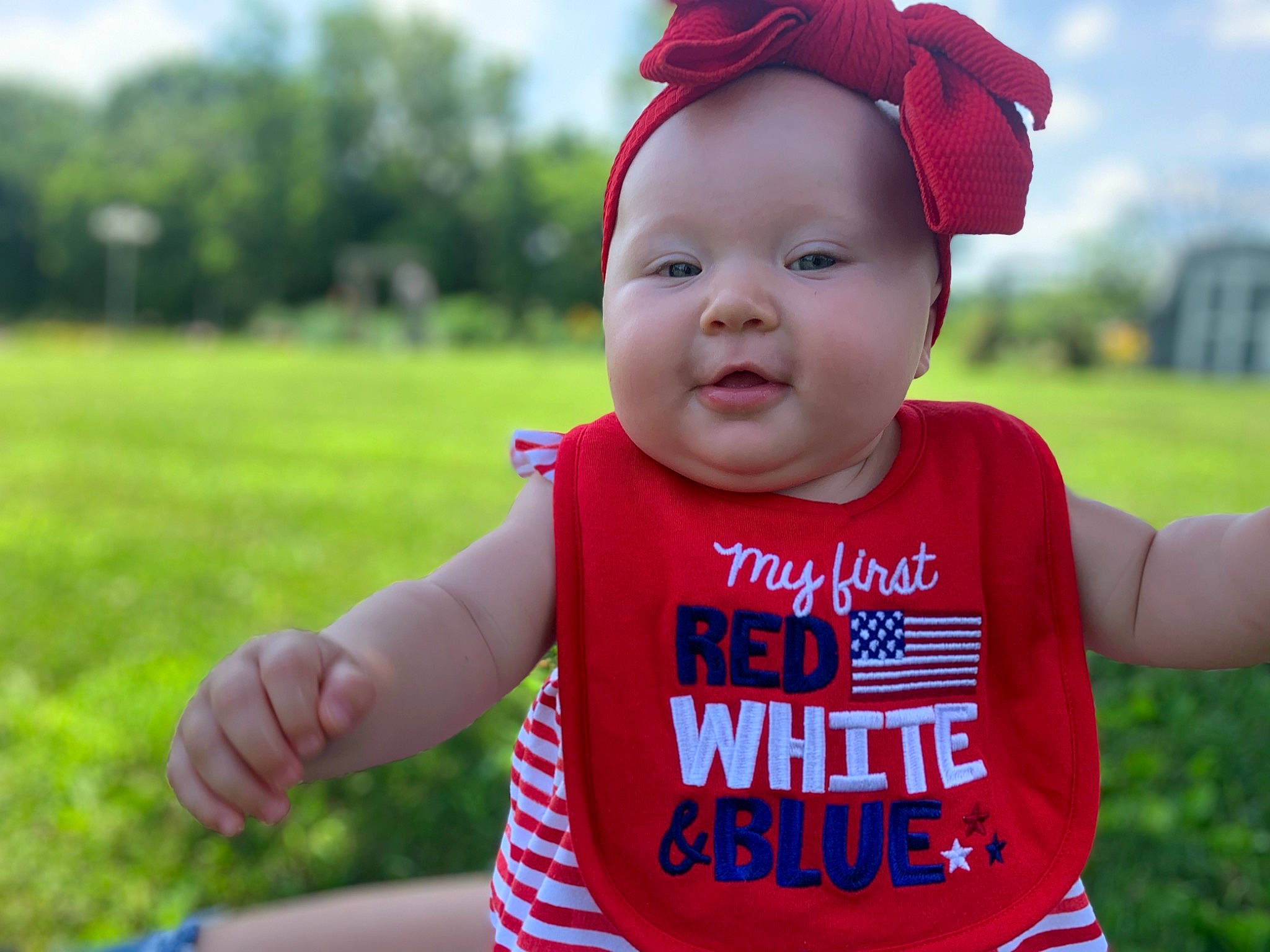 Laney is registered to the contest to win money with this photo: baby, baby_toddler_clothing, child, cool, facial_expression, fun, grass, happy, head, headgear, headwear, meadow, mouth, person, play, product, red, skin, sleeve, smile