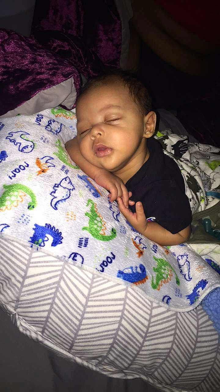 Zy'Mir is registered to the contest to win money with this photo: baby, baby_toddler_clothing, bedtime, child, comfort, couch, darkness, fun, happy, linens, nap, night, pattern, person, purple, room, sitting, smile, t_shirt, textile