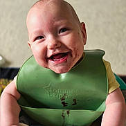 Aurora is registered to the contest to win money with this photo: arms, baby, bib, child, chocolate, cleaning, cuteness, eating, face, food, happy, highchair, indoor, infant, joy, messy, mouth, playful, skin, smiling