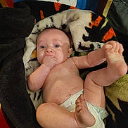 Emry joined the competition — help win amazing prizes! baby, infant, diaper, blanket, hand, foot, face, blue_eyes, expression, sitting, cute, skin, furniture, painting, cartoon, colorful, indoor, person, child, newborn