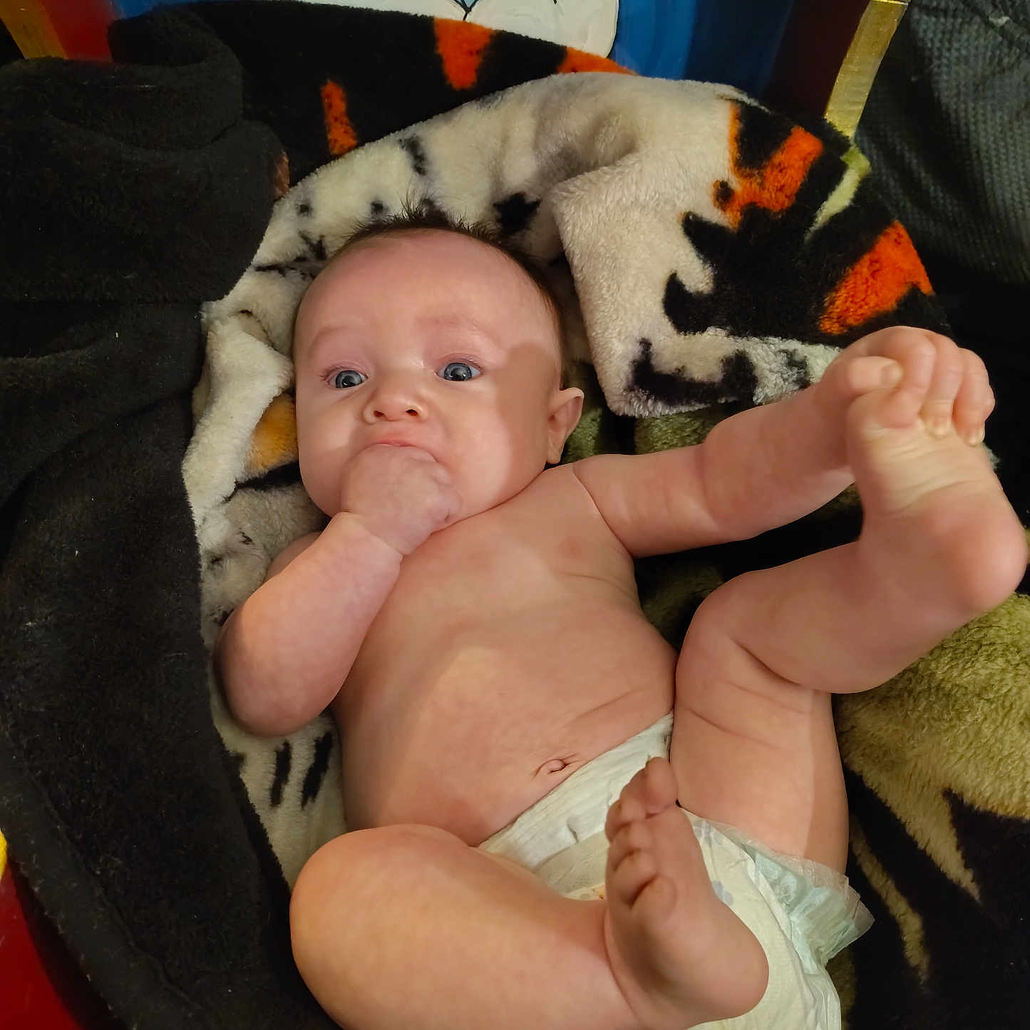 Emry joined the competition — help win amazing prizes! baby, infant, diaper, blanket, hand, foot, face, blue_eyes, expression, sitting, cute, skin, furniture, painting, cartoon, colorful, indoor, person, child, newborn