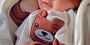 Zaviyar joined the competition — help win amazing prizes! baby, sleeping, blanket, knit_hat, pom_poms, brown_clothing, bear_design, cozy, infant, child, cute, warm, soft, resting, clothing, white_blanket, portrait, indoors, peaceful, toddler