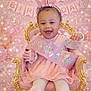 baby, child, birthday, party, pink, crown, sash, balloons, chair, smile, happy, celebration, dress, tights, lace, decorations, gold, glitter, banner, portrait