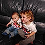 Christopher is registered to the contest to win money with this photo: children, toddler, baby, couch, leather, clothing, jeans, socks, smile, curly_hair, sitting, indoor, person, cute, matching_outfits, casual, portrait, family, happy, tshirt