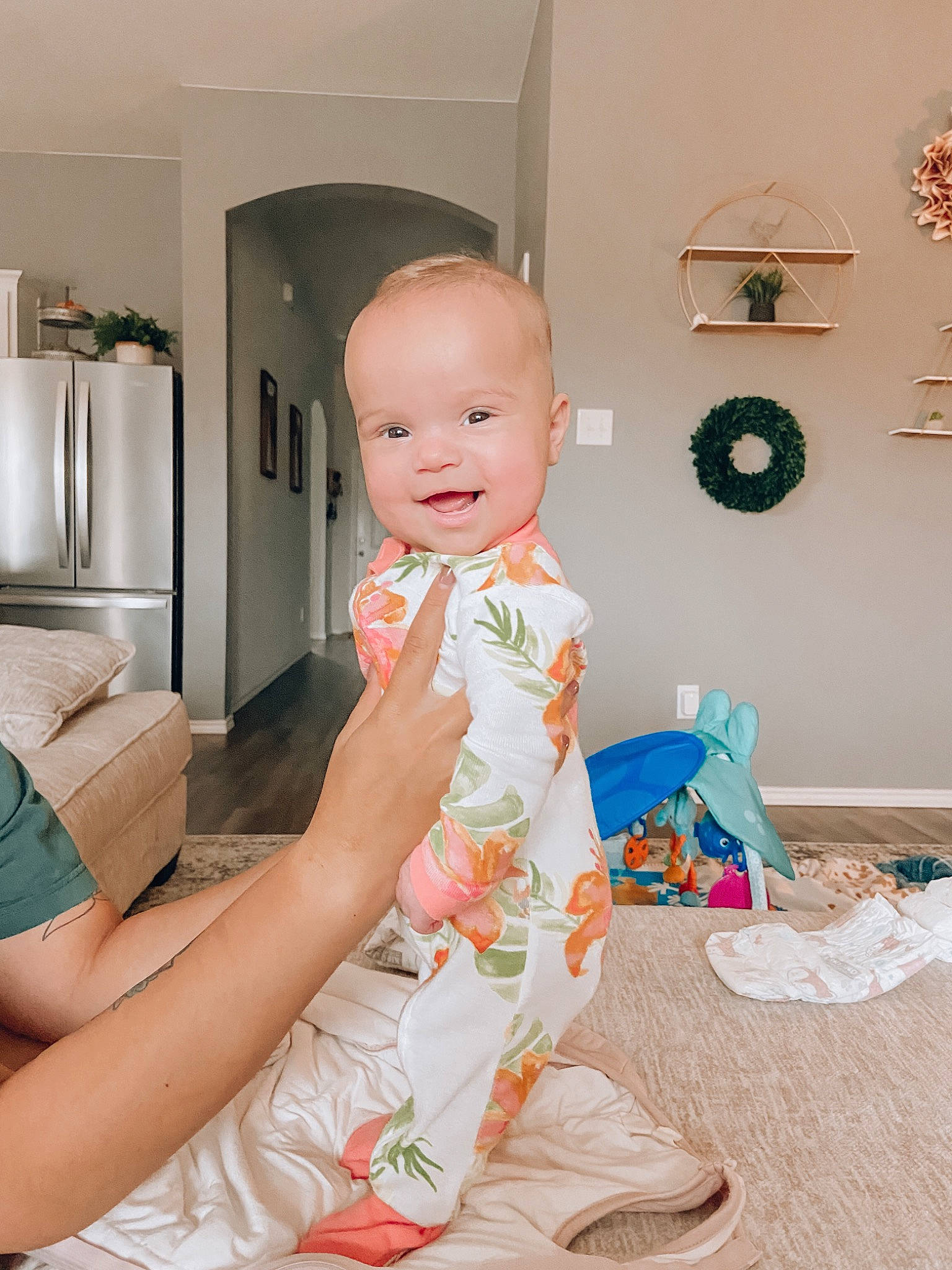 Charlie Jo Lennon Mae is registered to the contest to win money with this photo: baby, baby_toddler_clothing, child, clock, comfort, face, flooring, fun, happy, head, human_leg, joy, knee, peach, person, pink, room, sitting, smile, sock