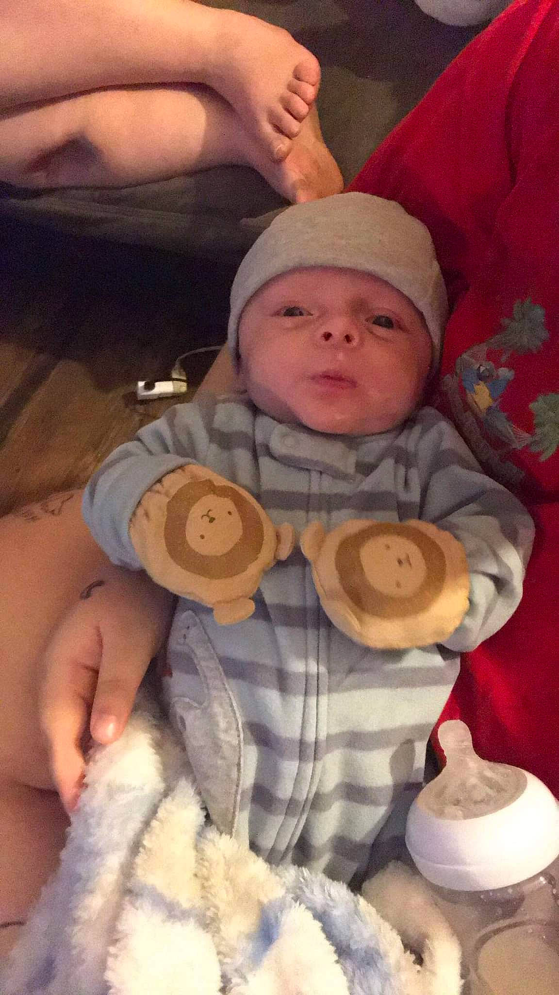 Grayson is registered to the contest to win money with this photo: baby, baby_products, baby_sleeping, baby_toddler_clothing, cap, cheek, child, comfort, finger, headgear, headwear, linens, pattern, person, personal_protective_equipment, sitting, skin, sleeve, stuffed_toy, thumb