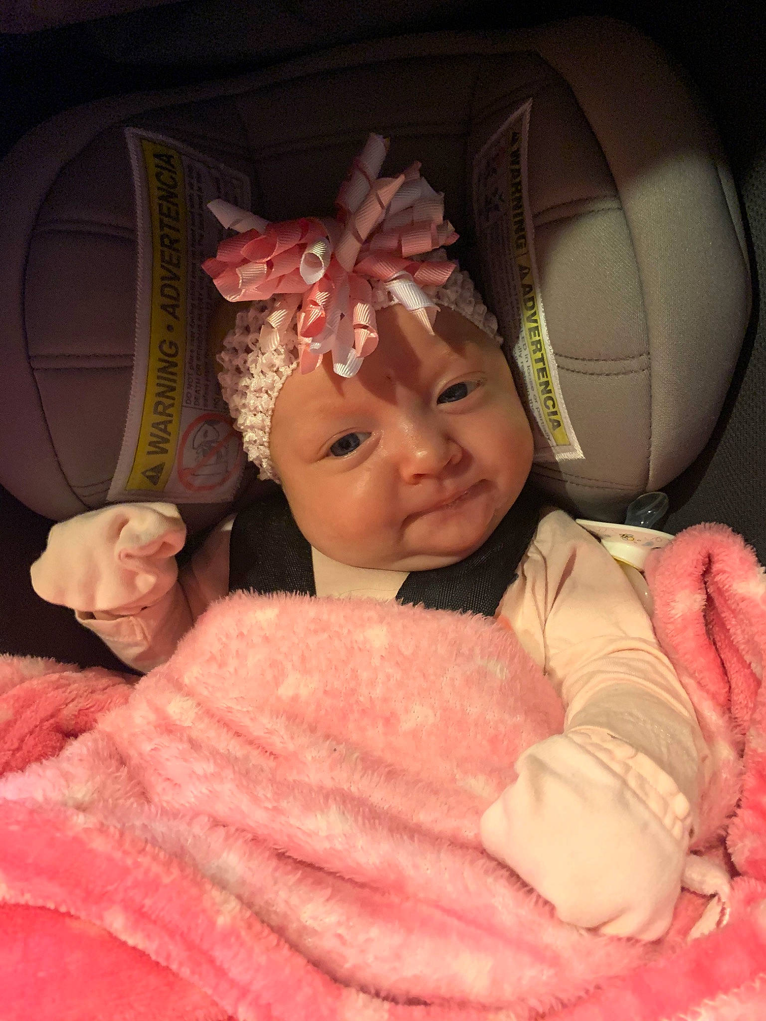 Emberleigh is registered to the contest to win money with this photo: baby, car_seat, cheek, child, ear, eye, fun, head, headgear, mouth, nose, peach, person, photography, pink, skin, smile, toddler