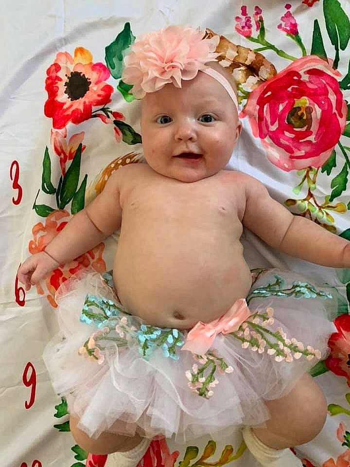 Emberleigh is registered to the contest to win money with this photo: baby, baby_toddler_clothing, child, cut_flowers, fashion_accessory, flower, hair_accessory, person, petal, pink, plant, product, rose, rose_family, toddler