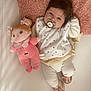 Ana participe au concours pour gagner de l'argent avec cette photo : baby, pacifier, plush_doll, pink_blanket, bib, white_clothing, slippers, cartoon_character, cute, infant, toy, lying_down, soft_texture, indoor, child, face, head, hand, footwear, comfort
