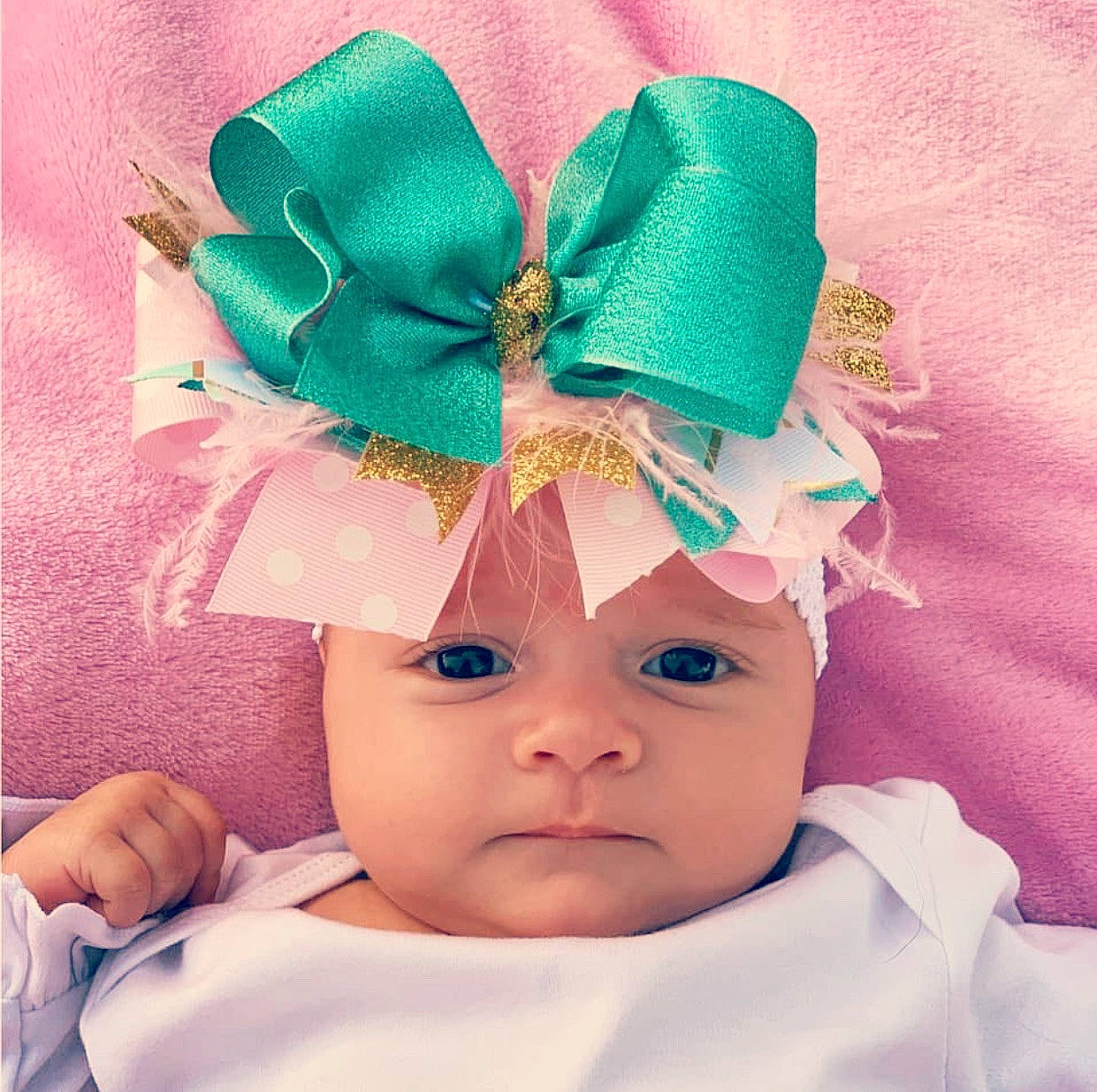 Kenlee is registered to the contest to win money with this photo: baby, child, costume, costume_accessory, costume_hat, ear, fashion_accessory, forehead, hair_accessory, head, headband, headgear, headpiece, person, pink, smile, toddler, turquoise