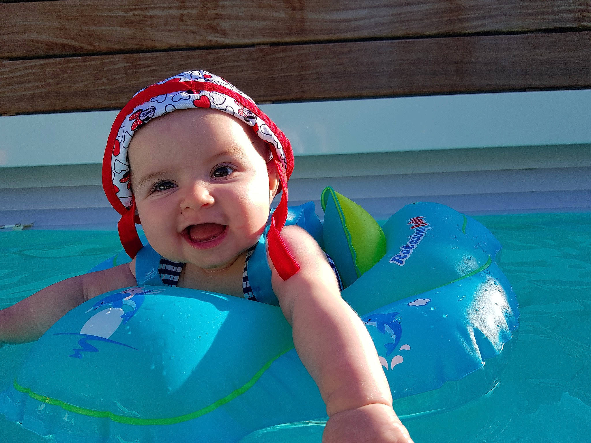 Zoé a rejoint le concours — aidez-le/la à gagner de superbes lots ! baby_float, cap, child, fun, games, headgear, inflatable, leisure, lifejacket, person, personal_protective_equipment, play, product, recreation, skin, summer, swim_cap, swimming_pool, toddler, vacation