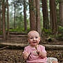 baby, barefoot, child, cute, daylight, exploration, floral_pants, forest, ground, happy, leaf, nature, outdoor, pink_shirt, sitting, smiling, stick, trees, woodland, young_child