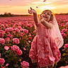 Mika is registered to the contest to win money with this photo: child, girl, pink_dress, rose_field, flowers, sunset, petals, barefoot, veil, smiling, happy, nature, outdoor, portrait, flower_petals, spring, sunlight, joy, playing, dress