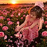 child, girl, rose_field, pink_dress, sunset, flowers, petals, smiling, outdoor, nature, happy, flower_garden, sunlight, portrait, plant, greenery, playing, cute, young, beauty