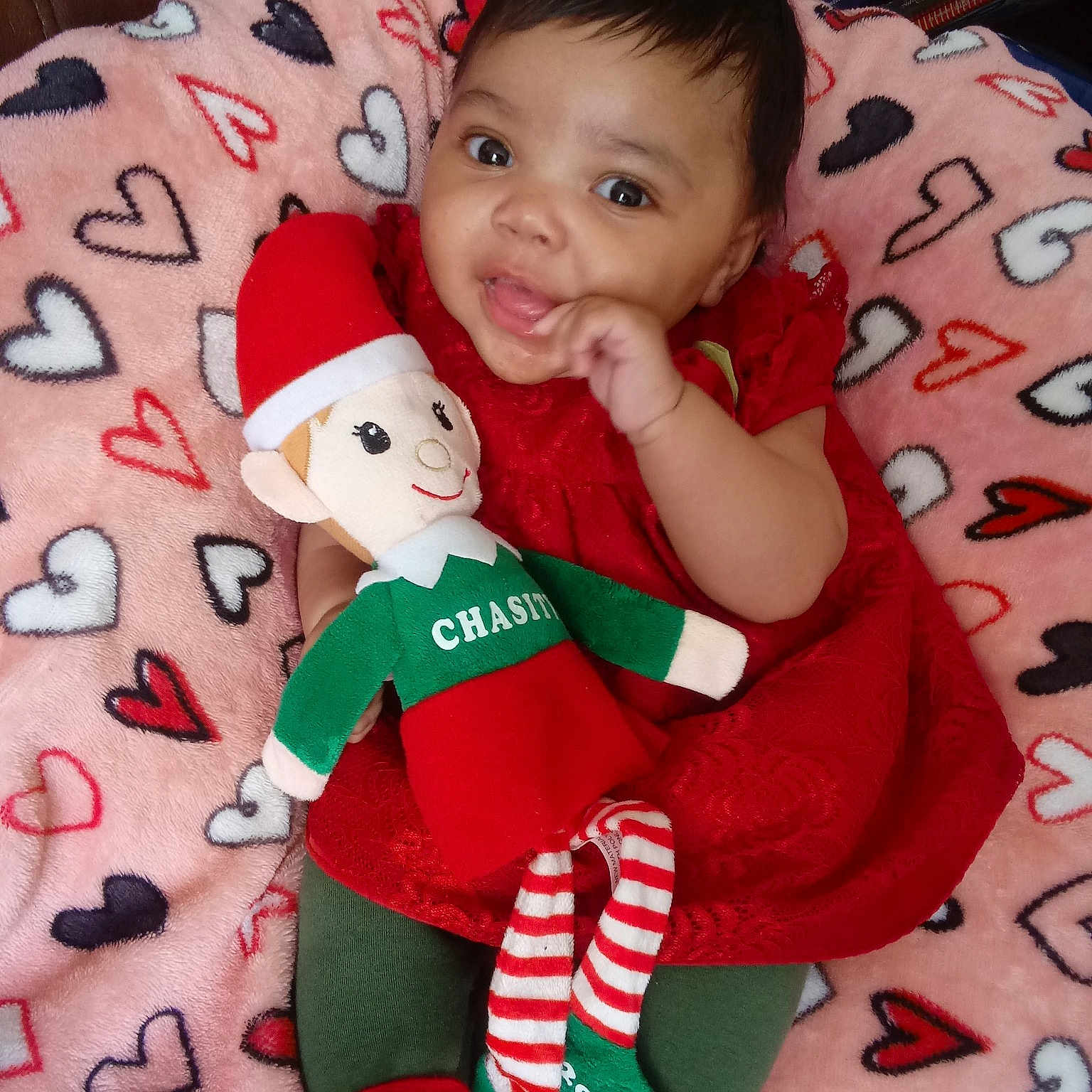 Chasity is registered to the contest to win money with this photo: cheek, child, christmas, day, girl, infant, person, play, product, red, skin, smile, stuffed_toy, textile, toddler, toy