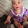 Jocelyn joined the competition — help win amazing prizes! baby, child, purple_dress, daisies, cute, couch, blanket, furniture, indoors, portrait, smiling, happy, face, foot, hand, person, infant, sitting, cozy, soft