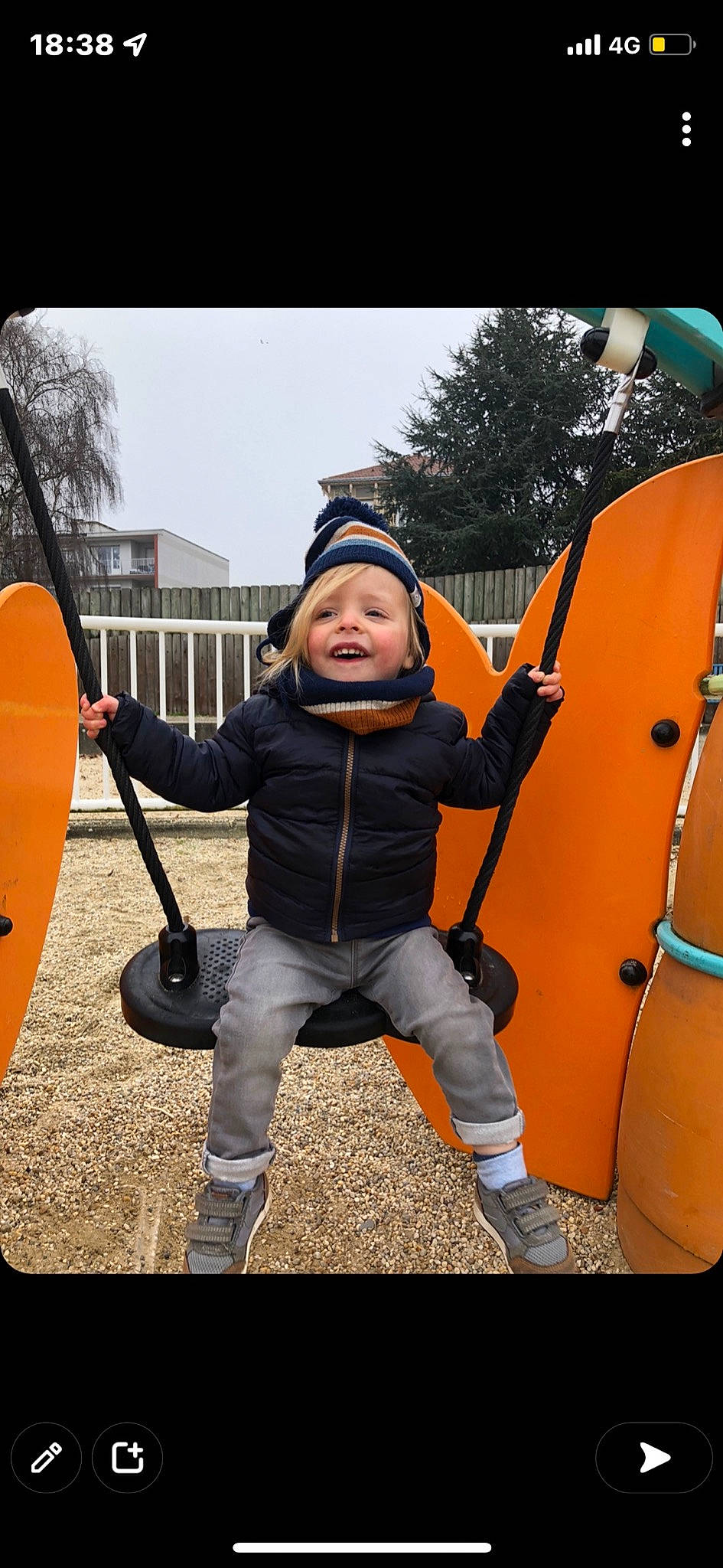 Dahyem participe au concours pour gagner de l'argent avec cette photo : child, flash_photography, footwear, gesture, grass, happy, headwear, jacket, leisure, person, personal_protective_equipment, plant, recreation, shoe, sky, smile, sneakers, swing, toddler, tree