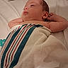 Magdalen is registered to the contest to win money with this photo: baby, infant, blanket, striped_blanket, bed, sleeping, resting, skin, newborn, person, closeup, face, arm, hand, hospital, sheet, comfort, relaxation, indoors, peaceful