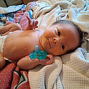 Magdalen is registered to the contest to win money with this photo: baby, infant, pacifier, blanket, bed, diaper, skin, face, hand, fingers, hair, sleepwear, resting, cozy, indoor, newborn, cute, soft, toddler, child