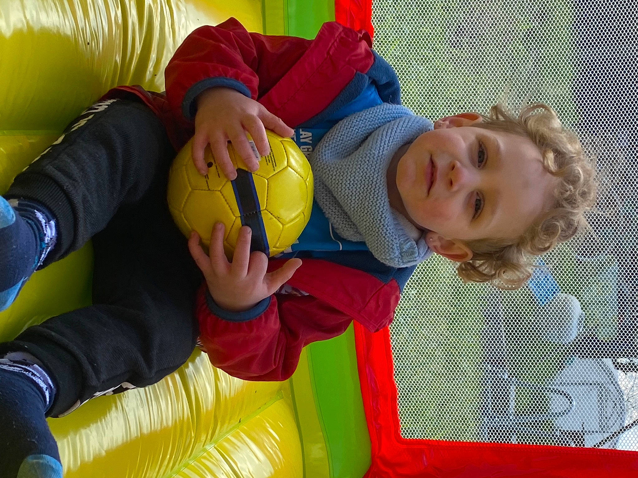 Tyler participe au concours pour gagner de l'argent avec cette photo : baby, baby_products, baby_toddler_clothing, baby_toys, ball, bounce_house, child, comfort, facial_expression, fun, happy, leisure, person, play, recreation, room, sitting, smile, toddler, toy