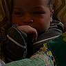 Emiliano is registered to the contest to win money with this photo: baby, infant, child, sleepy, face, portrait, indoors, blanket, bed, bedding, swaddled, hand, newborn, cozy, patterned, clothing, dark_lighting, close_up, resting, home