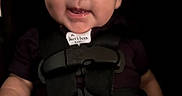 Emiliano is registered to the contest to win money with this photo: baby, blue_eyes, car_seat, child, close_up, clothing, dark_background, face, happy, harness, indoors, infant, looking_at_camera, photograph, portrait, red_buckle, safety_harness, seated, short_hair, smiling