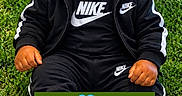Zymir joined the competition — help win amazing prizes! baby, infant, child, sitting, grass, outdoor, portrait, black_clothing, sportswear, sneakers, nike, jordan_shoes, curly_hair, serious_expression, looking_at_camera, hands, fashion, green_background, text_overlay, milestone_photo