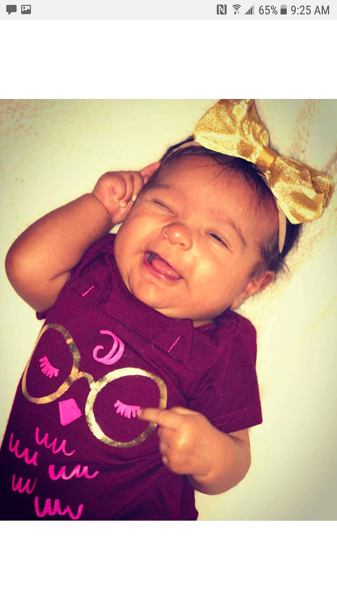 Zyla is registered to the contest to win money with this photo: arm, baby, bonnet, cheek, child, cool, facial_expression, happy, headgear, love, magenta, person, pink, play, product, sleeve, smile, snapshot, t_shirt, toddler