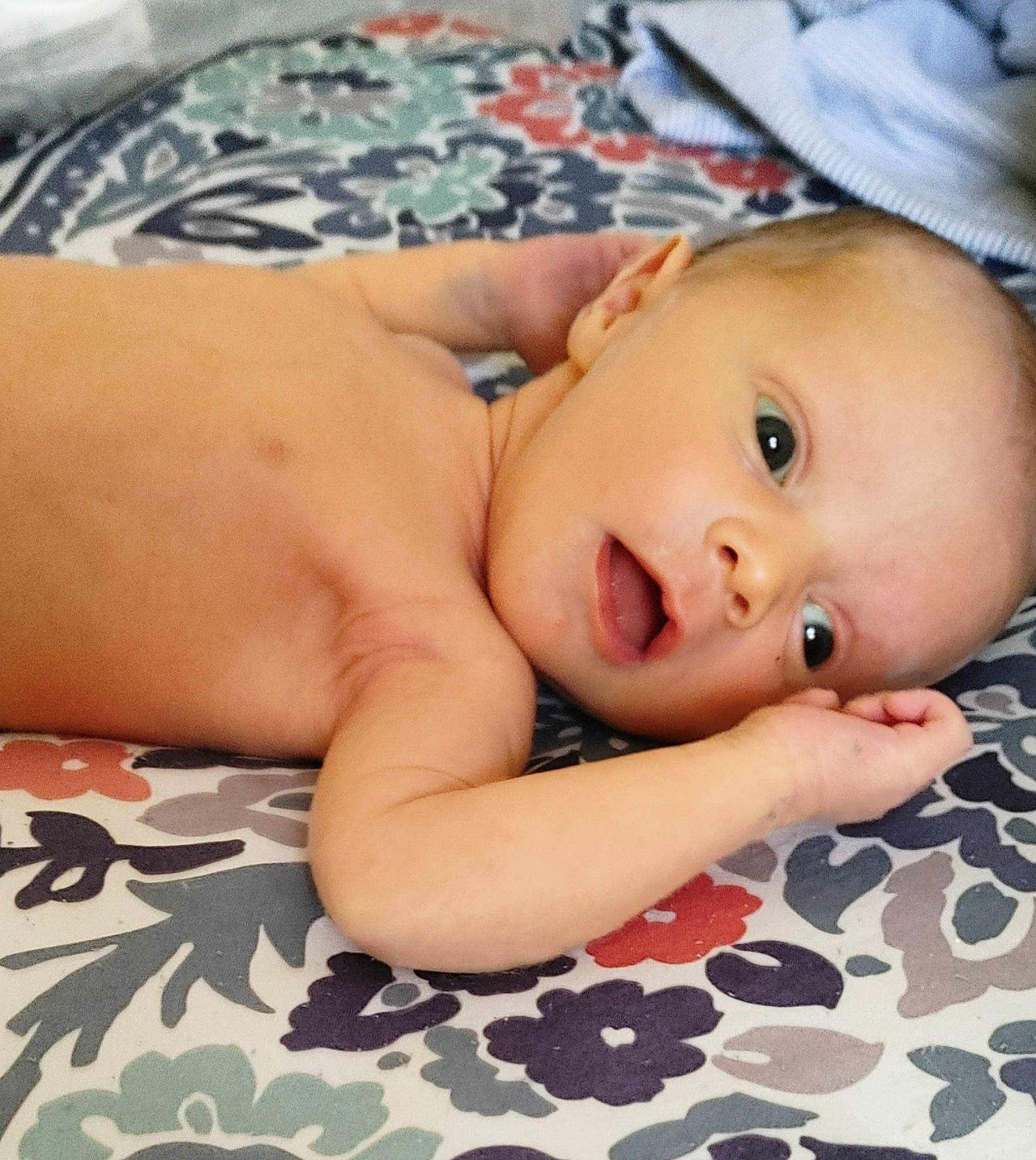 Lake is registered to the contest to win money with this photo: baby, baby_products, baby_toddler_clothing, cheek, chest, child, close_up, comfort, eyebrow, eyelash, happy, human_body, linens, lip, nail, nose, pattern, person, skin, surprise