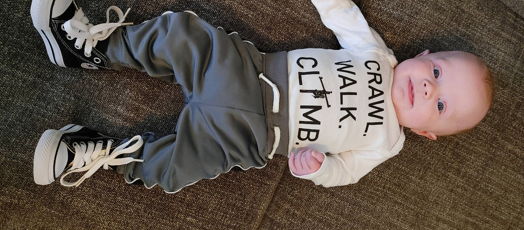 Lake is registered to the contest to win money with this photo: baby, baby_products, baby_toddler_clothing, child, comfort, fashion_accessory, font, foot, fur, human_leg, linens, mammal, outerwear, person, personal_protective_equipment, sitting, sleeve, sportswear, t_shirt, toddler