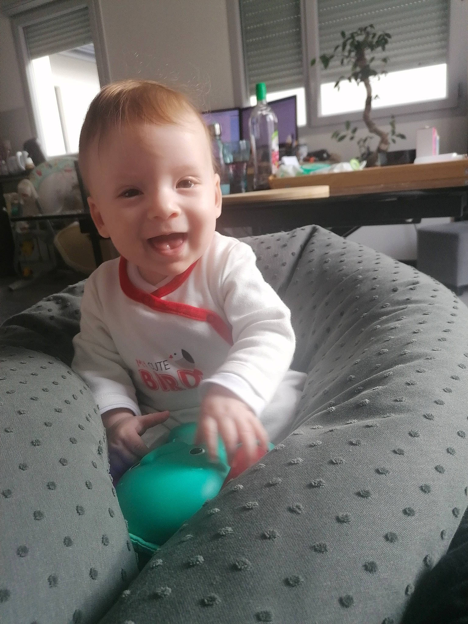 Mila participe au concours pour gagner de l'argent avec cette photo : baby, baby_playing_with_toys, baby_toddler_clothing, balloon, cabinetry, child, home, houseplant, interior_design, joy, lamp, linens, living_room, mouth, party_supply, person, play, room, toddler, window_blind