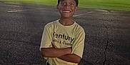 Samuel joined the competition — help win amazing prizes! child, boy, baseball_uniform, cap, smiling, parking_lot, dusk, sports_field, lights, trees, grass, outdoor, person, young, happy, athlete, sports, standing, crossed_arms, casual