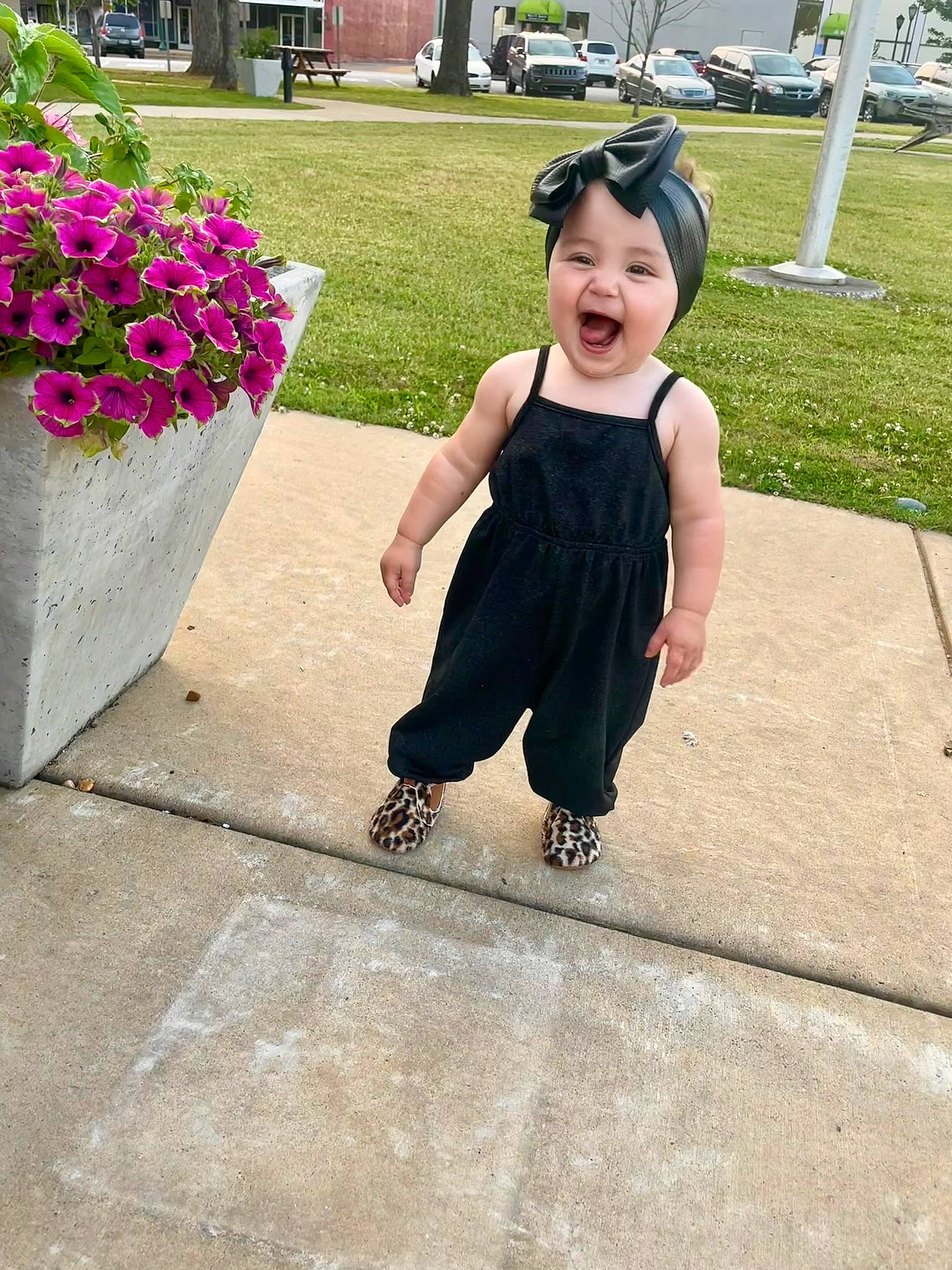 Evie is registered to the contest to win money with this photo: asphalt, baby_toddler_clothing, child, event, flooring, flower, fun, grass, hairstyle, happy, hat, headwear, leisure, person, petal, pink, plant, recreation, sidewalk, summer