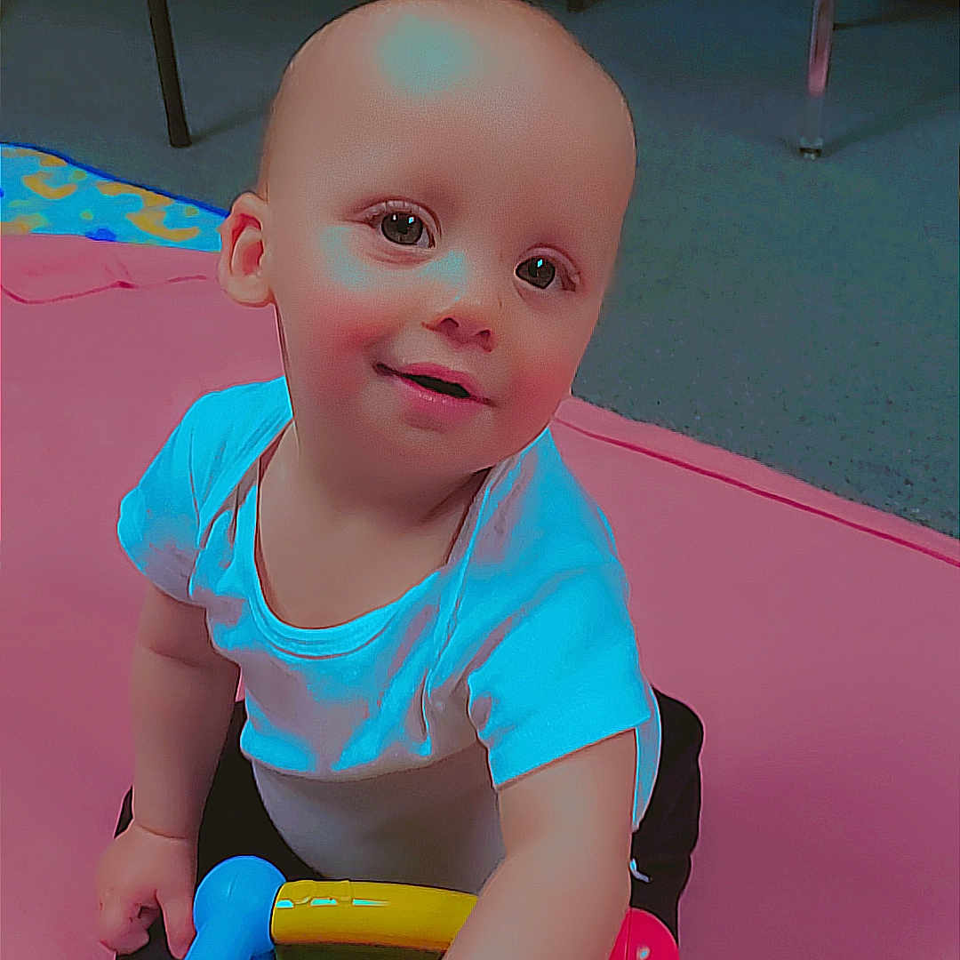 Karson is registered to the contest to win money with this photo: baby, bathroom, bodypart, couch, crawling, doll, face, finger, furniture, hand, head, indoors, person, photography, playarea, portrait, room, sitting, toy, wood