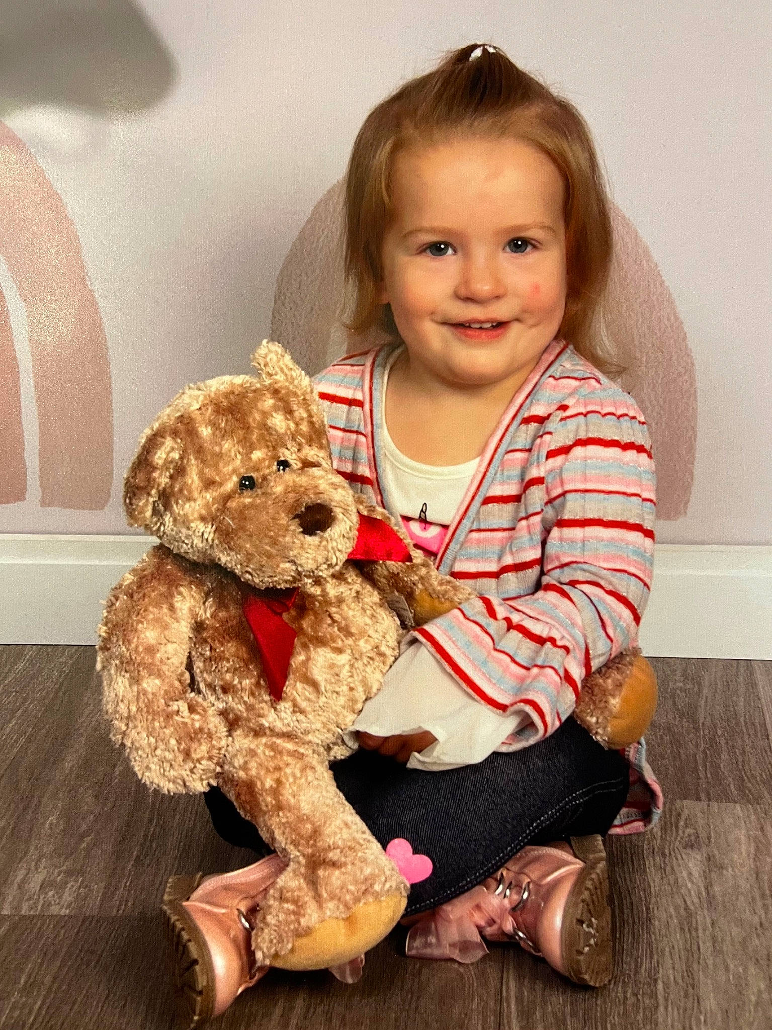 Sadie is registered to the contest to win money with this photo: baby_toddler_clothing, blond, child, companion_dog, fawn, flooring, fun, fur, hair, happy, joy, person, plush, sitting, skin, sleeve, smile, stuffed_toy, teddy_bear, toddler