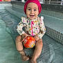 Thalia participe au concours pour gagner de l'argent avec cette photo : toddler, child, swimsuit, swim_cap, water, pool, ball, smile, happy, sitting, indoor, tiles, play, fun, cute, person, water_play, baby, colorful, toy