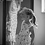 Ambre participe au concours pour gagner de l'argent avec cette photo : child, girl, reflection, mirror, dress, smile, indoor, black_and_white, woman, hair, ponytail, pattern, floor, wall, window, light, portrait, people, blurred_background, happy