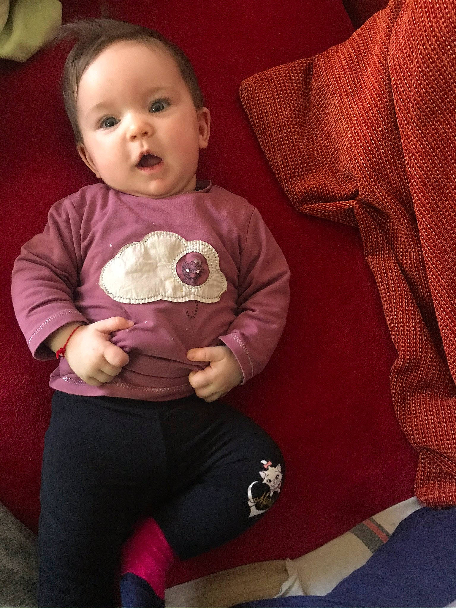 Kellya participe au concours pour gagner de l'argent avec cette photo : baby, cheek, child, person, pink, sitting, skin, sleeve, smile, surprise, toddler