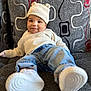 Stori joined the competition — help win amazing prizes! baby, child, infant, hat, knitted_hat, sweater, jeans, sneakers, couch, sofa, patterned_cushion, smile, face, relaxed, indoors, cozy, cute, portrait, young_child, casual_clothing