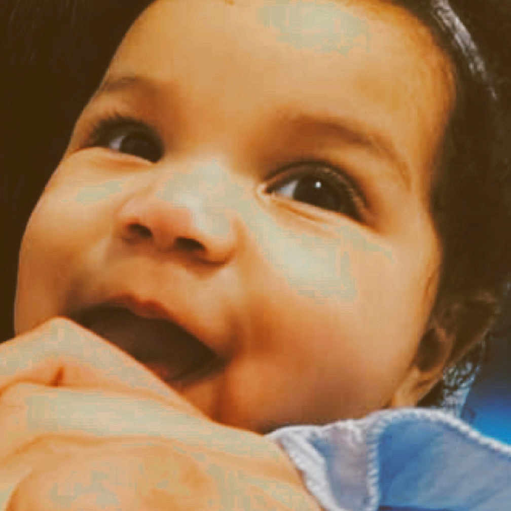 Stori joined the competition — help win amazing prizes! baby, blue_bow, child, closeup, clothing, curly_hair, cute, expression, face, fingers, hand, happy, head, indoor, infant, person, portrait, skin, smiling, young_child