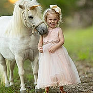 Kelly joined the competition — help win amazing prizes! child, pony, unicorn_horn, pink_dress, girl, outdoor, nature, grass, happy, smiling, animal, horse, curly_hair, bow, portrait, friendship, summer, cute, pet, fairytale