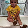 toddler, child, smiling, yellow_clothing, headband, shoes, window, indoors, sitting, happy, face, baby, cute, wood_floor, door, sunlight, casual, portrait, playful, young_child