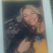 Buisquet joined the competition — help win amazing prizes! woman, cat, smiling, portrait, photo_frame, blurry, indoor, blonde_hair, yellow_clothing, pet, furry, holding, face, happy, feline, domestic_animal, closeup, people, animal, photo