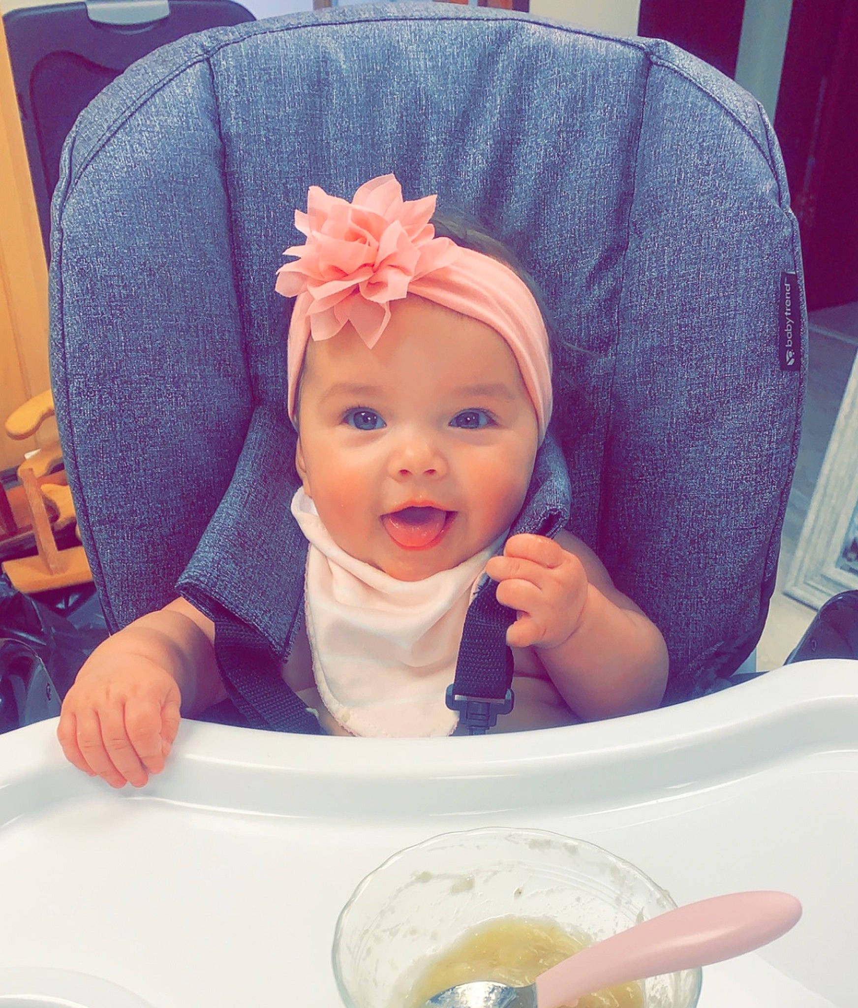 Brylee joined the competition — help win amazing prizes! baby, baby_laughing, baby_products, baby_toddler_clothing, chair, child, comfort, cool, dishware, fashion_accessory, food, happy, hat, headwear, person, plate, purple, sitting, sleeve, smile