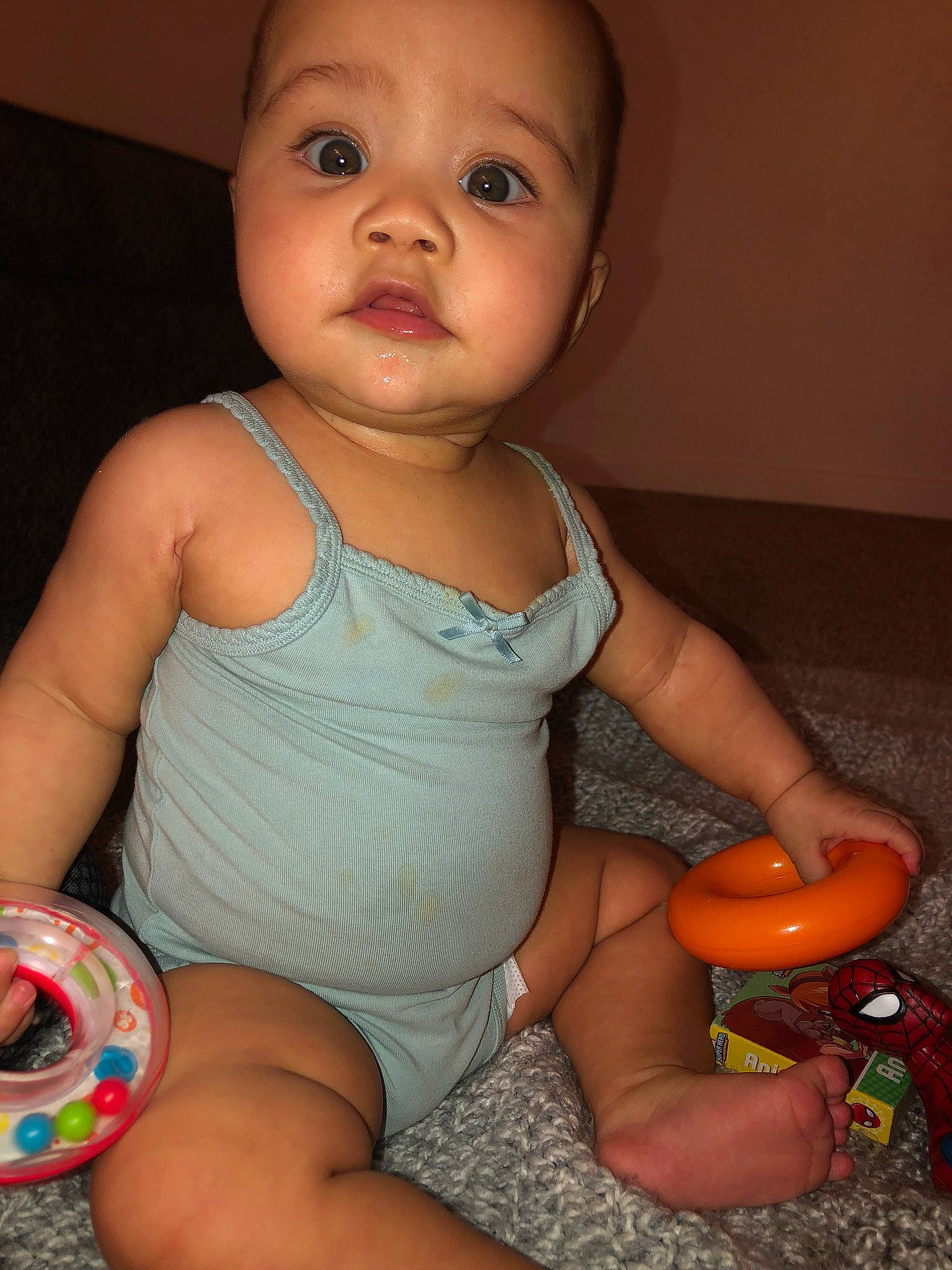 Kimora is registered to the contest to win money with this photo: baby, cheek, child, eye, finger, iris, mouth, person, play, sitting, skin, smile, toddler