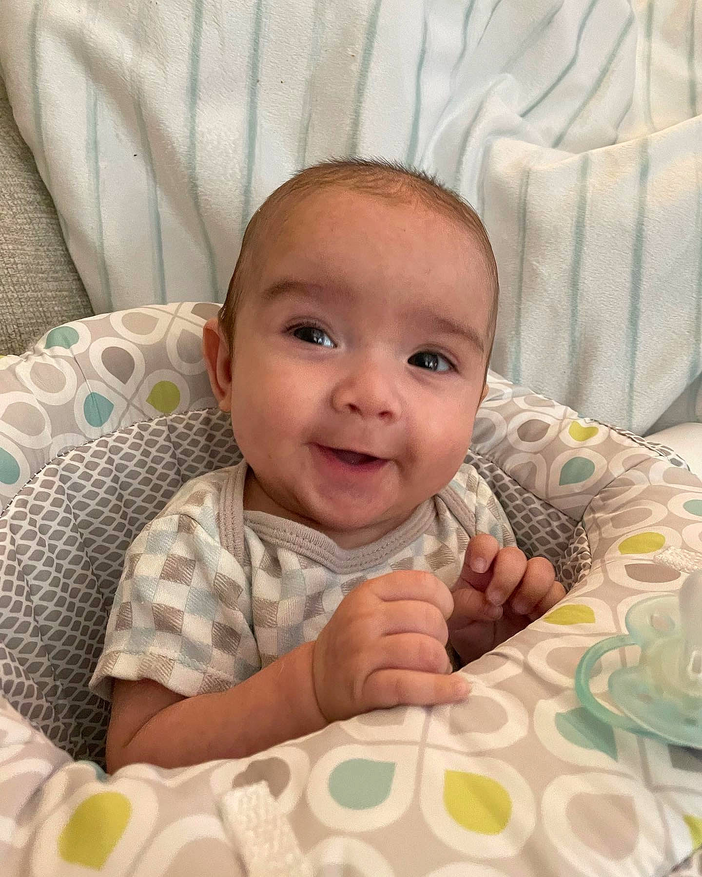 Aidan is registered to the contest to win money with this photo: baby, baby_toddler_clothing, cheek, chin, comfort, eye, eyebrow, face, happy, head, iris, linens, lip, mammal, nose, person, skin, sleeve, smile, textile